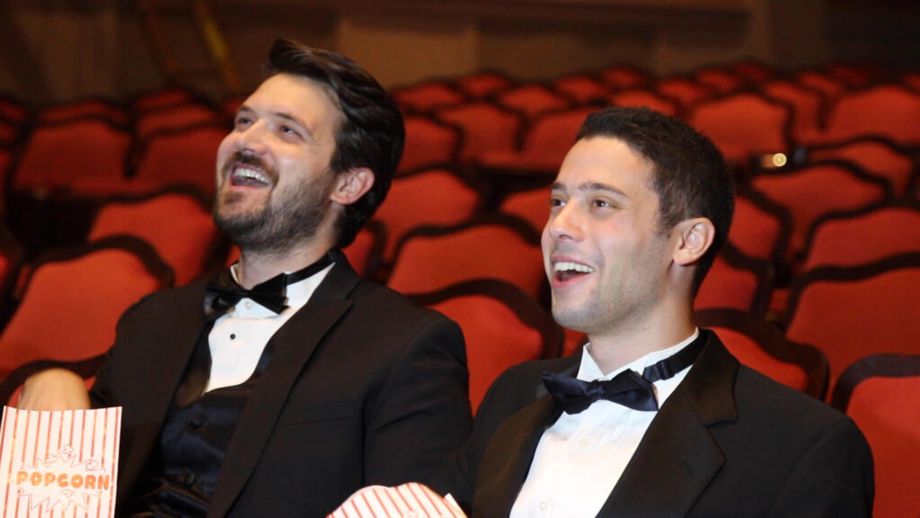 Christian & Eric laughing at screen in theater